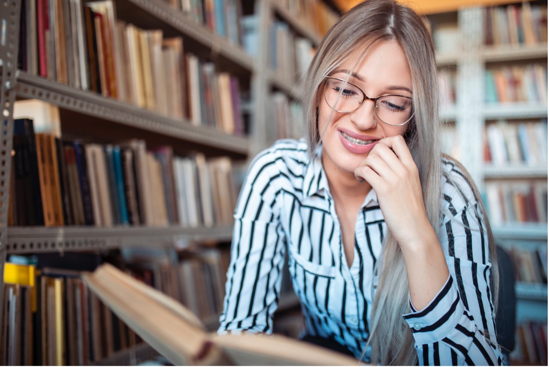 A person reading a book in a library, The History of Braces
