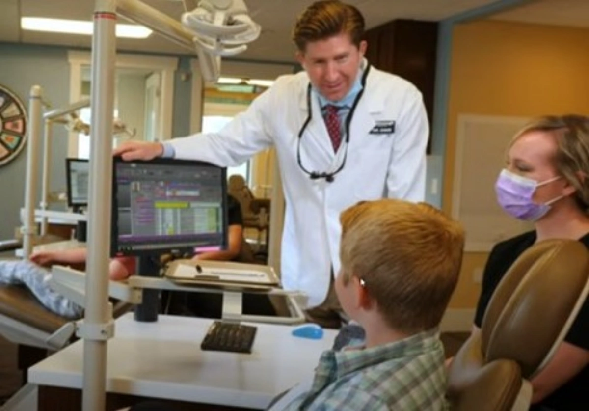 Dr. David McDonough discussing orthodontic treatment options with a child and parent during a consultation at McDonough Orthodontics.